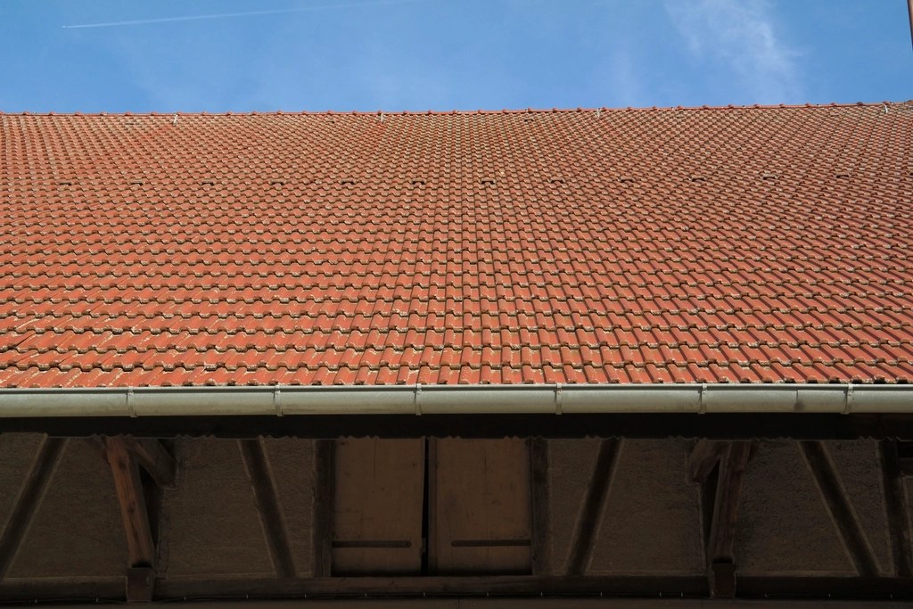 Clay tiled roof finished at the eaves with a new gutter
