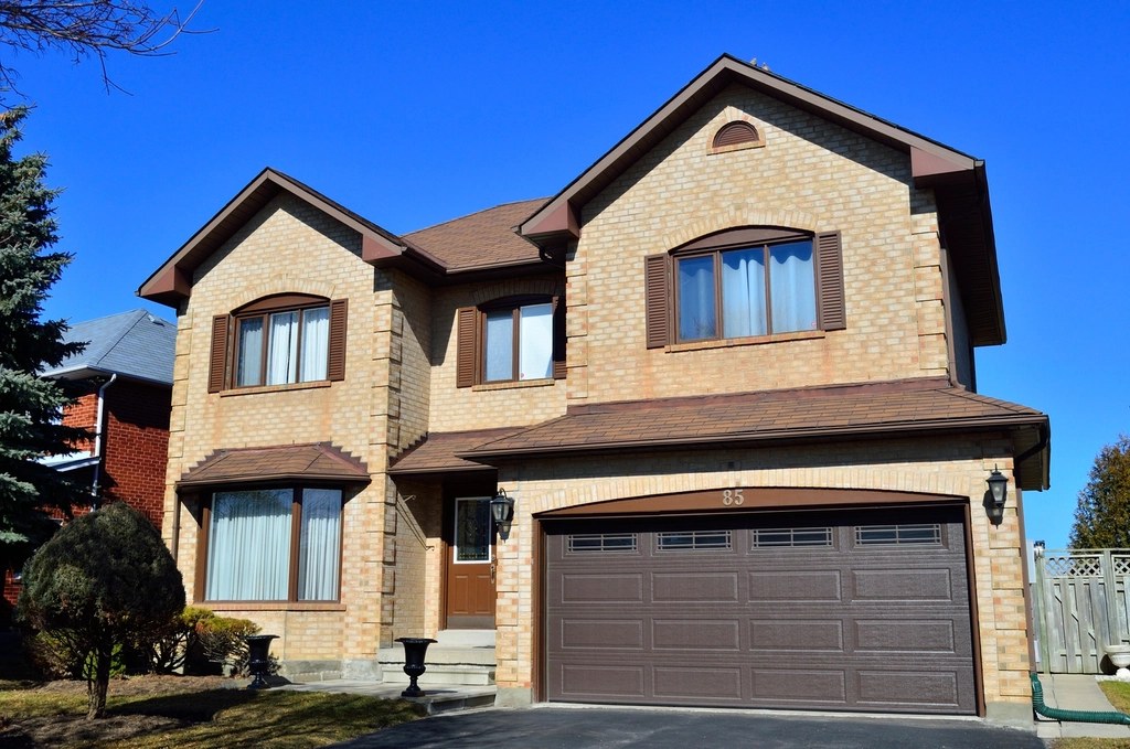 Two-storey detached house with a brown tiled roof, fascias and soffits